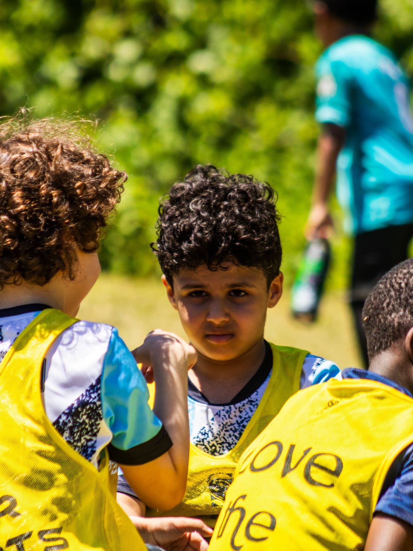 Two young players in pinnies side by side
